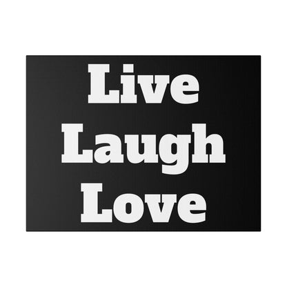 Dark gray canvas print with large white text reading “Live Laugh Love” arranged in three lines.