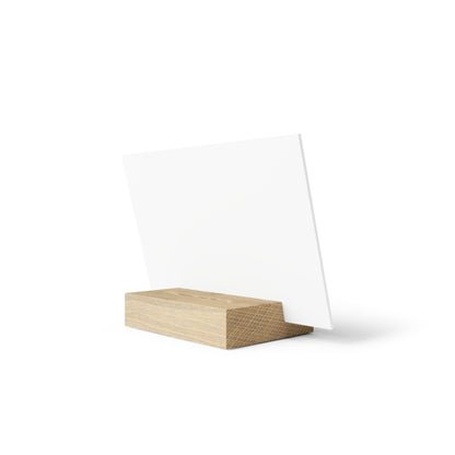 Blank white card on a light wood rectangular block stand, angled upright.