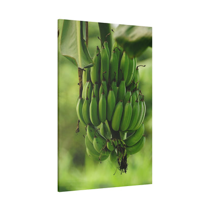 Vertical wall art print of a hanging green banana bunch against a blurred green background.