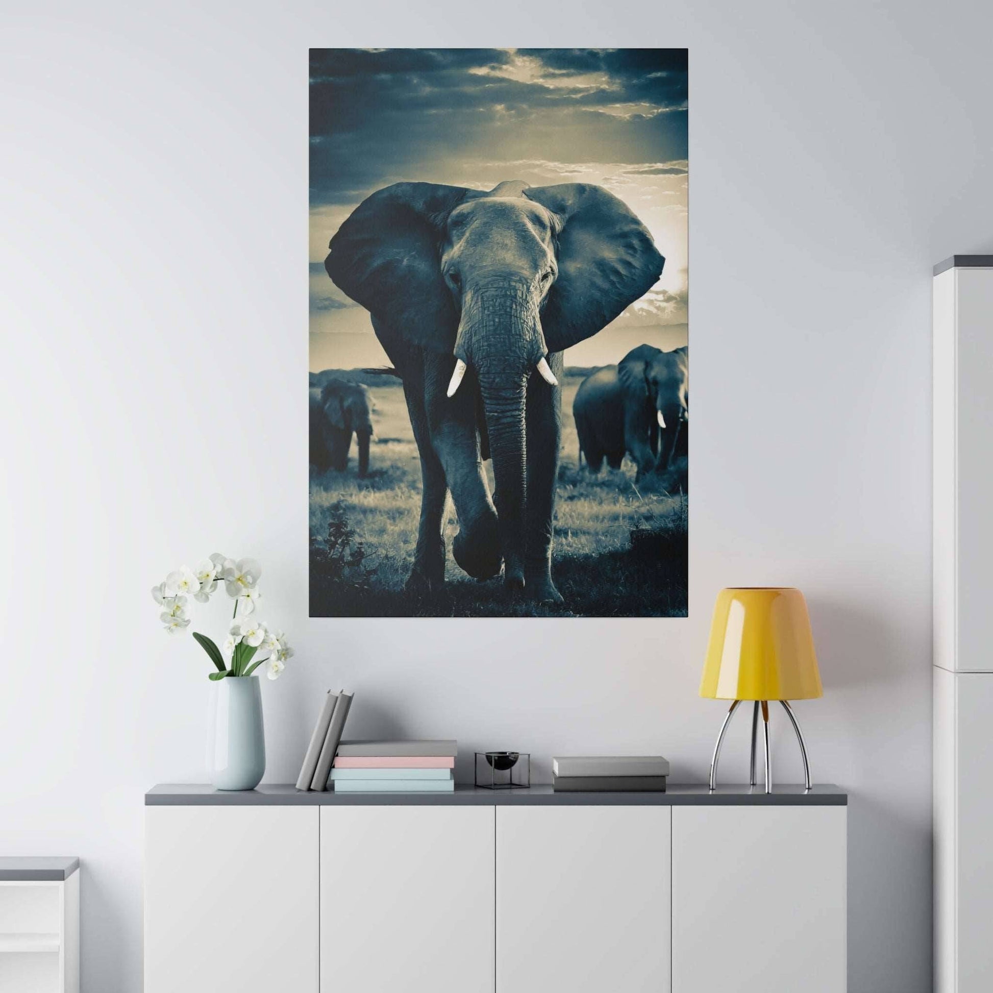 Tall vertical canvas print of a blue-toned elephant with tusks, facing the camera in a savanna scene.