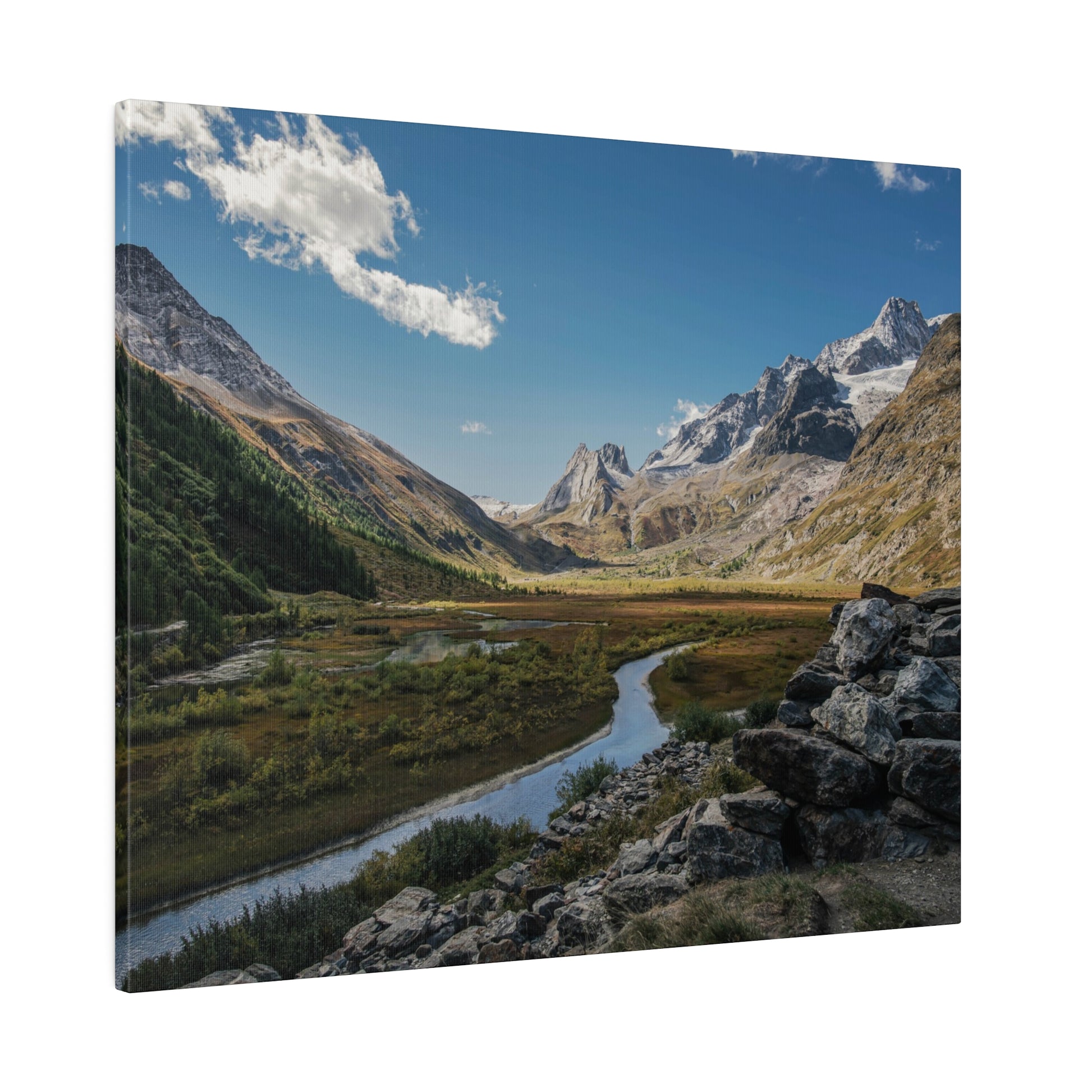 Alpine valley with a winding river, green meadows, and snow-capped mountains under a blue sky.