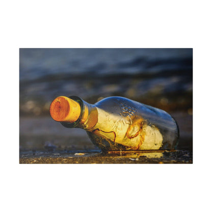 A clear glass bottle with an orange cap lies on wet sand at the beach, with water droplets on its surface.