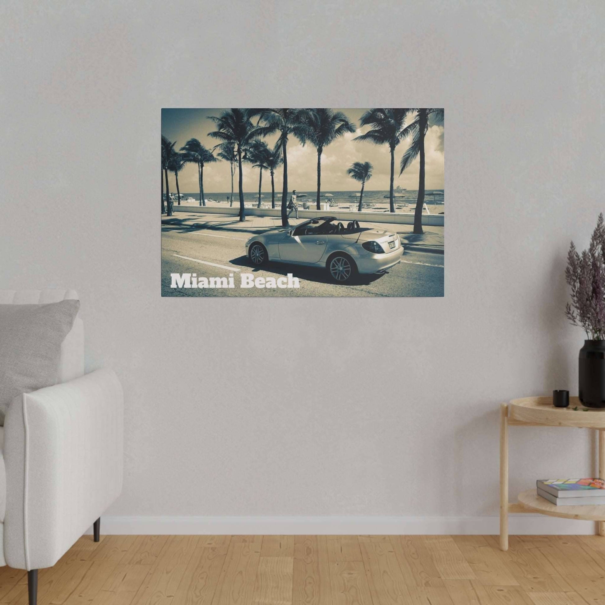 Canvas art showing a silver convertible along a palm-lined beach street with "Miami Beach" text in the lower left.