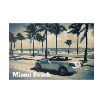 Silver Mercedes-Benz convertible parked by a palm-lined Miami Beach street with the ocean in the background.