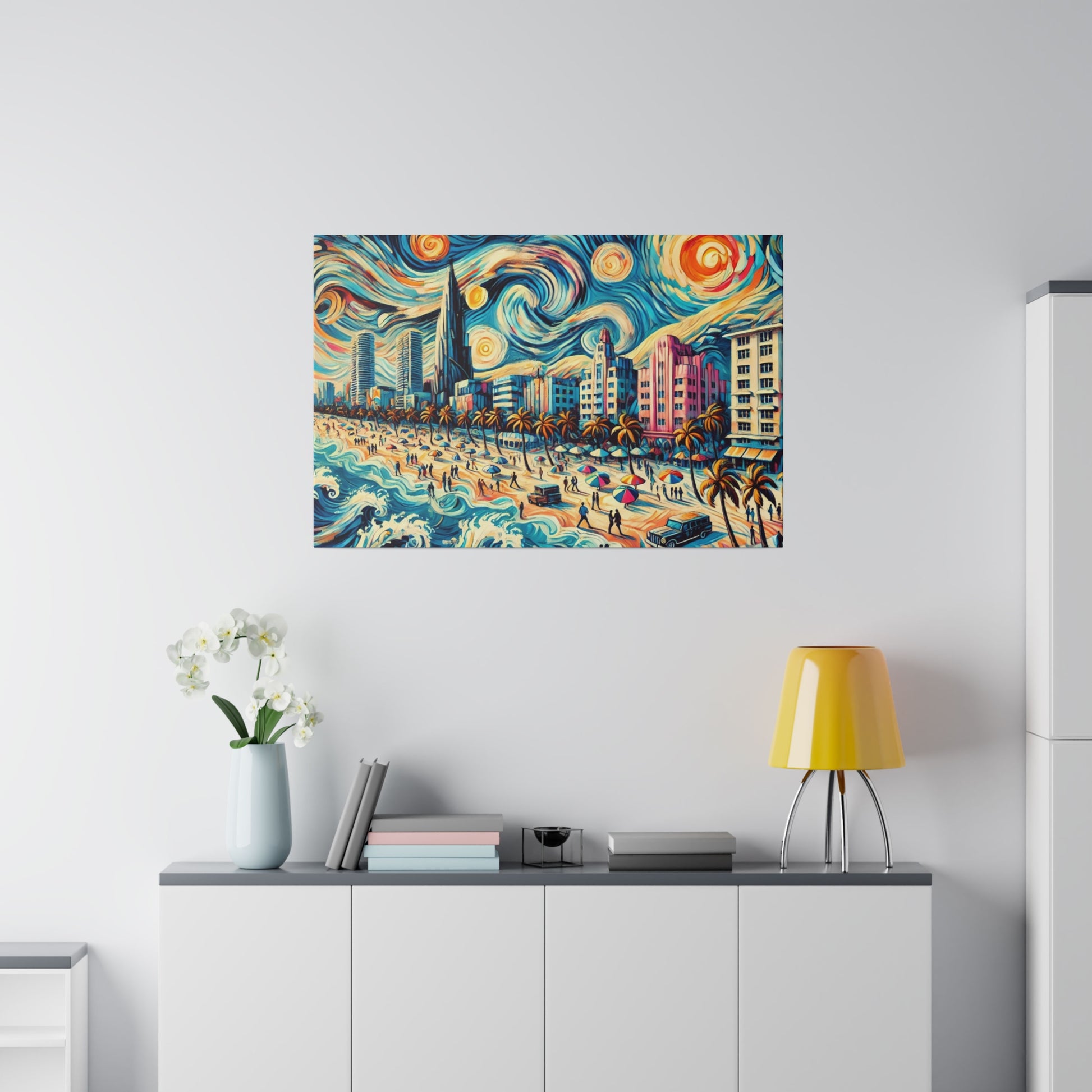 Colorful, swirling beach and cityscape painting mounted on a light wall above a white sideboard.