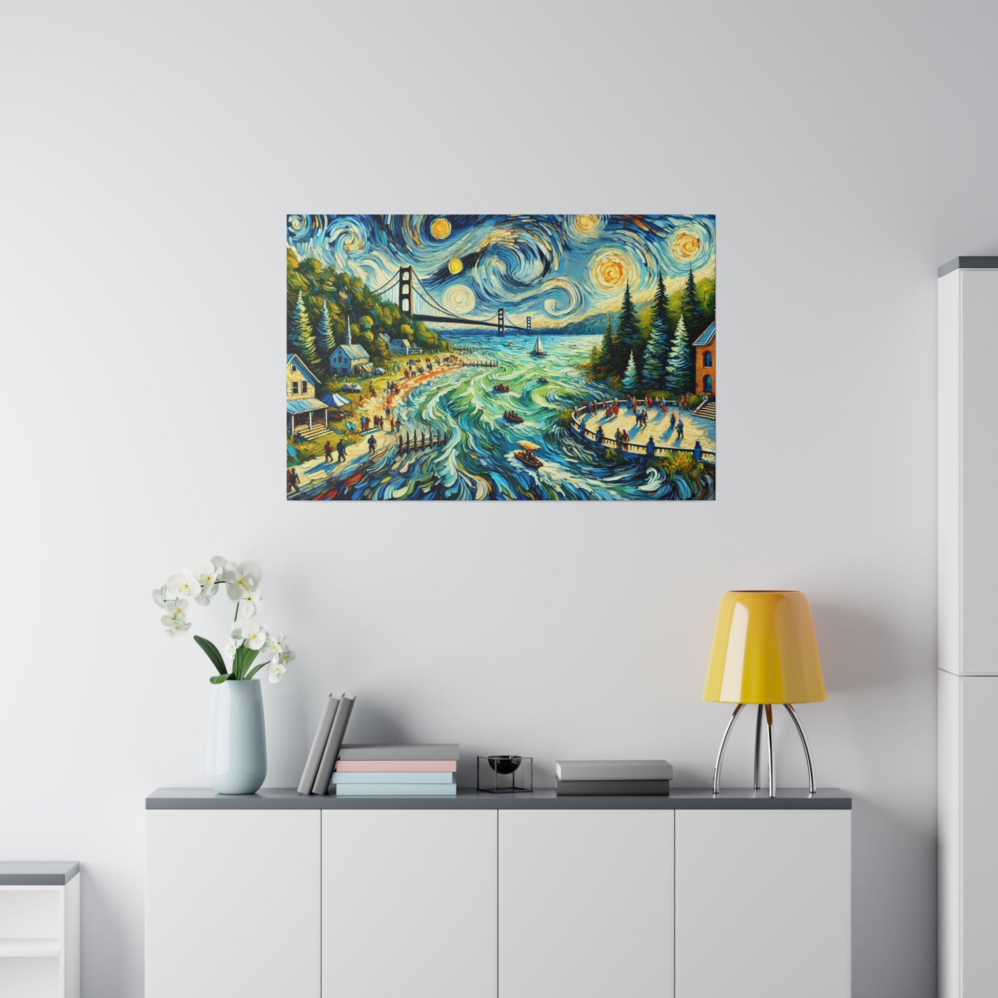Colorful landscape painting with swirling blue waves and a bridge hung above a white cabinet with a yellow lamp and books.