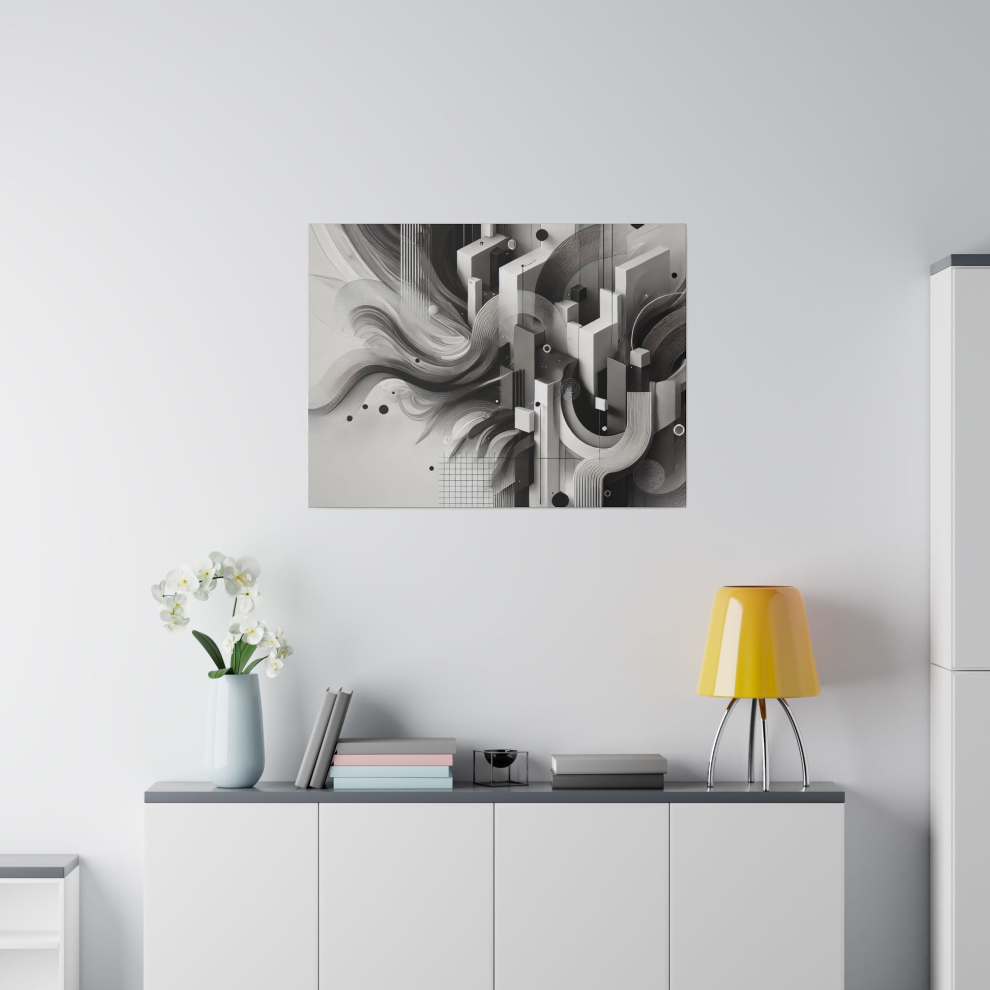 White living room with a gray-top sideboard, a black-and-white abstract art panel above, a yellow table lamp, vase of white orchids, and