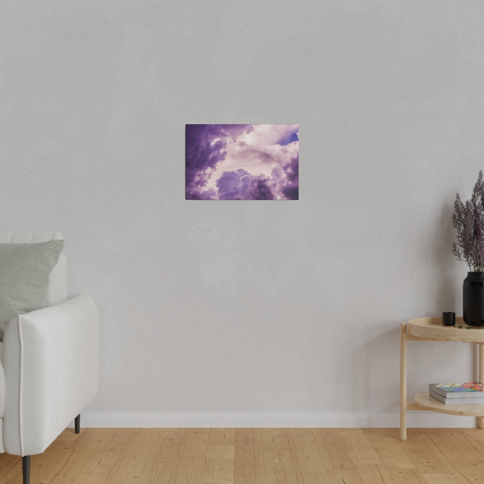 Small rectangular wall art showing a purple cloudy sky, mounted on a light gray living room wall.