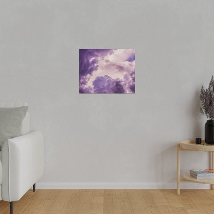 Small square canvas print of purple cloudy sky mounted on a light gray wall in a living room.