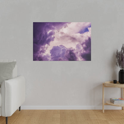 Purple cloudscape art print mounted on a light gray wall in a minimal living room.