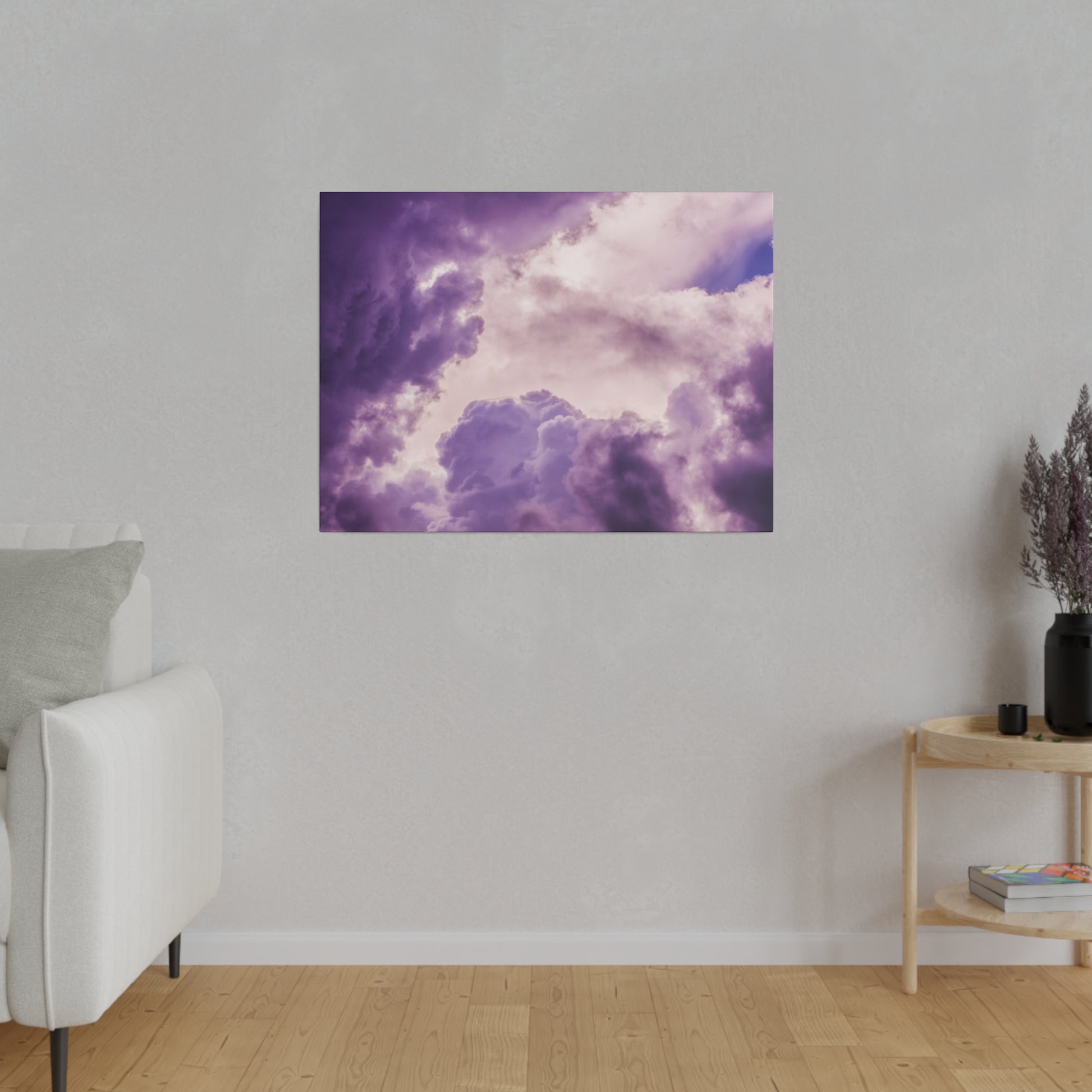 Purple cloud artwork mounted on a light gray wall above a wooden floor in a modern living room.