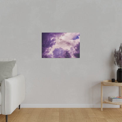 Small rectangular wall art depicting purple and pink clouds hanging on a light gray living room wall.