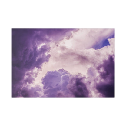 A dramatic sky filled with purple and pink storm clouds with light breaking through.