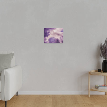 Small square canvas showing purple clouds against a lighter sky, mounted on a light gray wall in a living room.