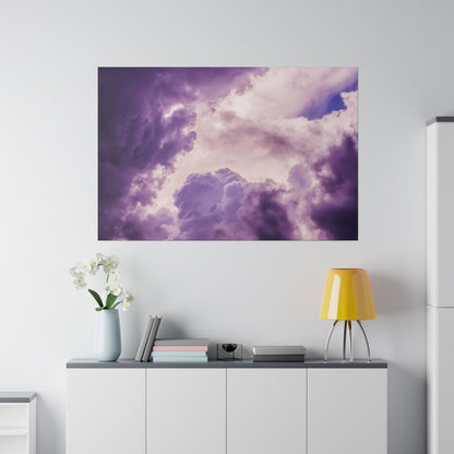 Large wall art showing purple and pink cloudscape against a bright sky, mounted above a white cabinet.