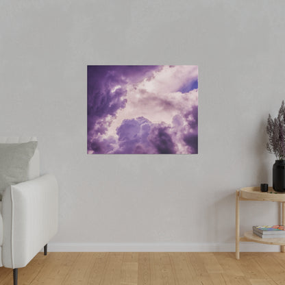 Square wall art depicting a purple cloudy sky hangs on a light gray wall in a minimalist living room.