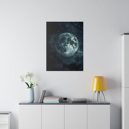 Poster of a full moon against a dark cloudy sky hung on a white wall above a gray cabinet with a blue vase, books, and a yellow lamp.