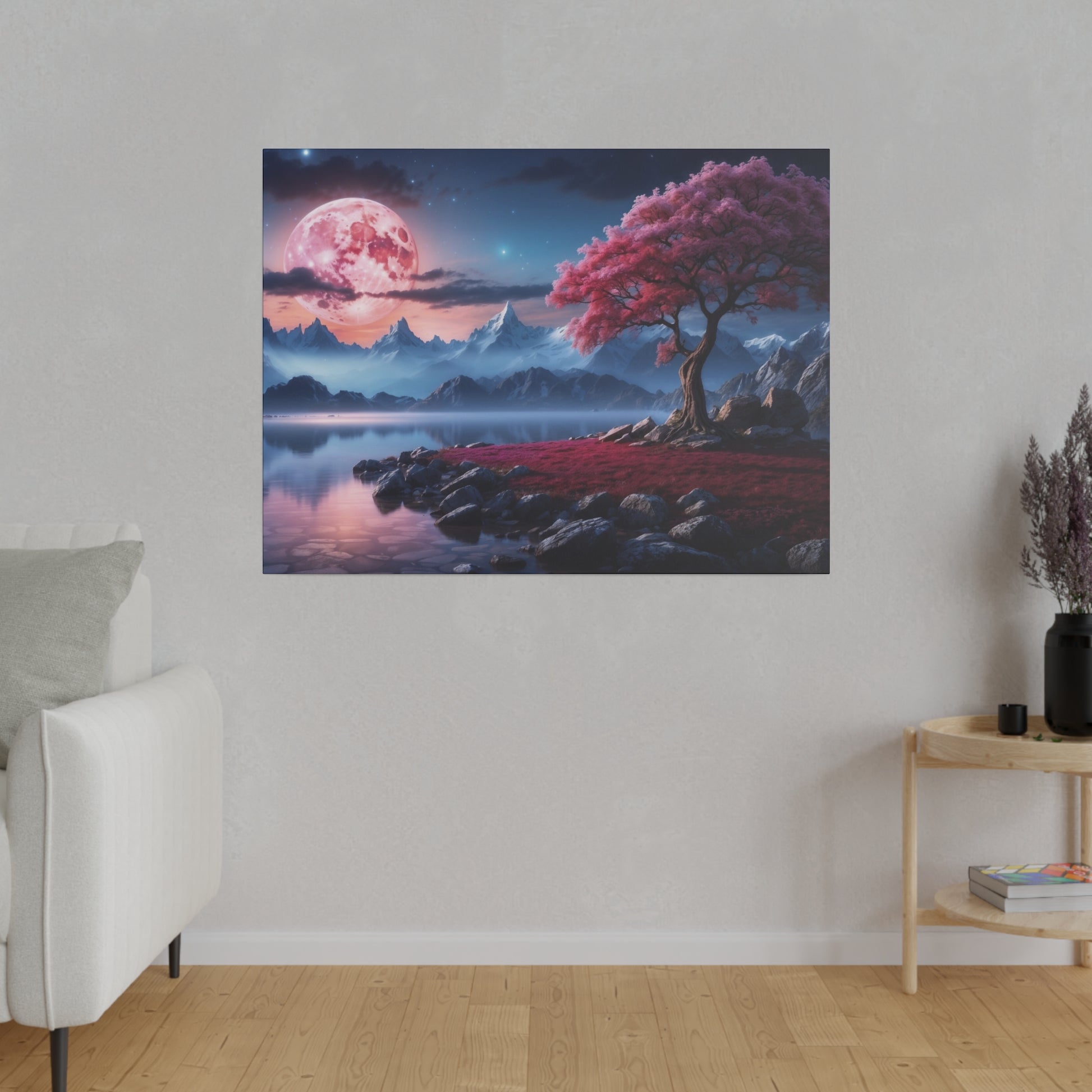 Square wall art depicting a pink-blossomed tree by a rocky lakeshore, with blue mountains and a pink moon in a starry sky.