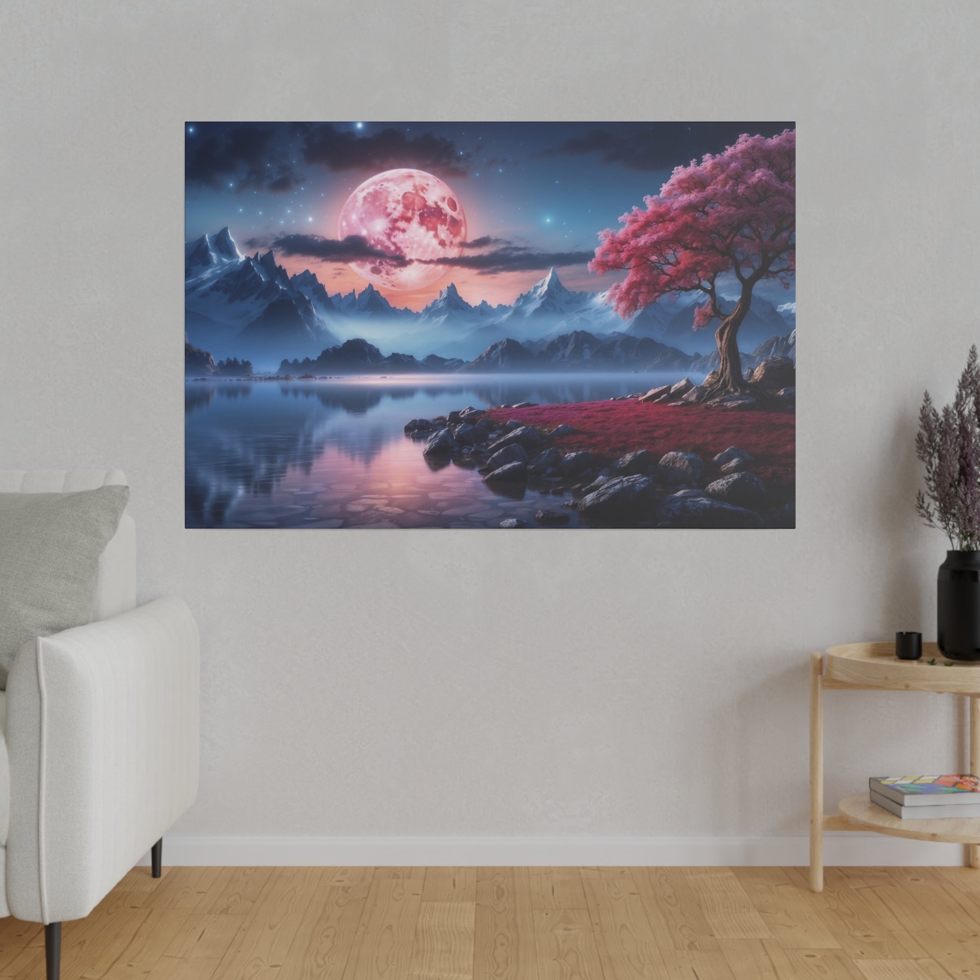 Wall art showing a pink moon over blue mountains, a calm lake, and a pink blossoming tree on a rocky shore.
