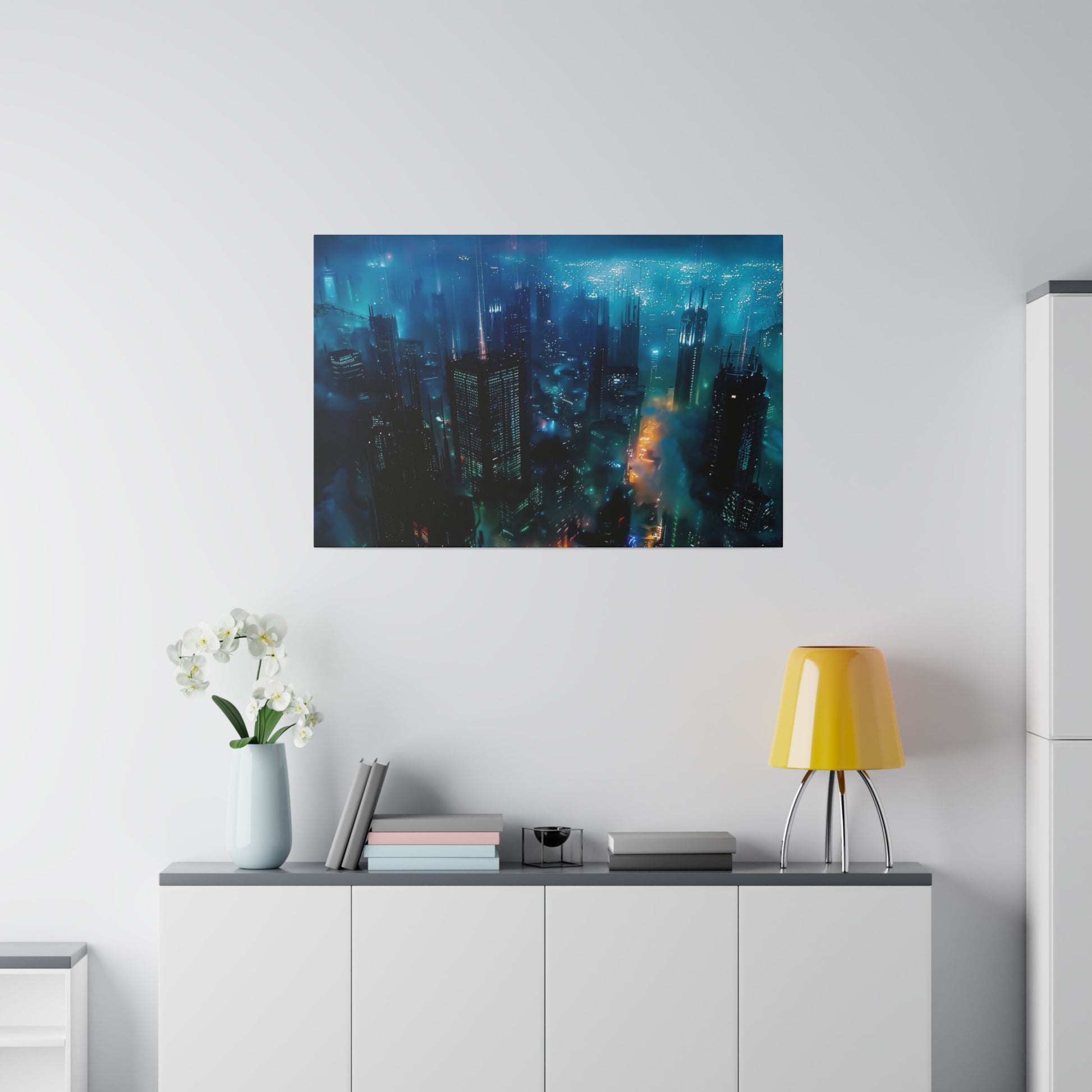 Aerial view of a glowing blue city skyline at night, hanging on a white wall above a sideboard.
