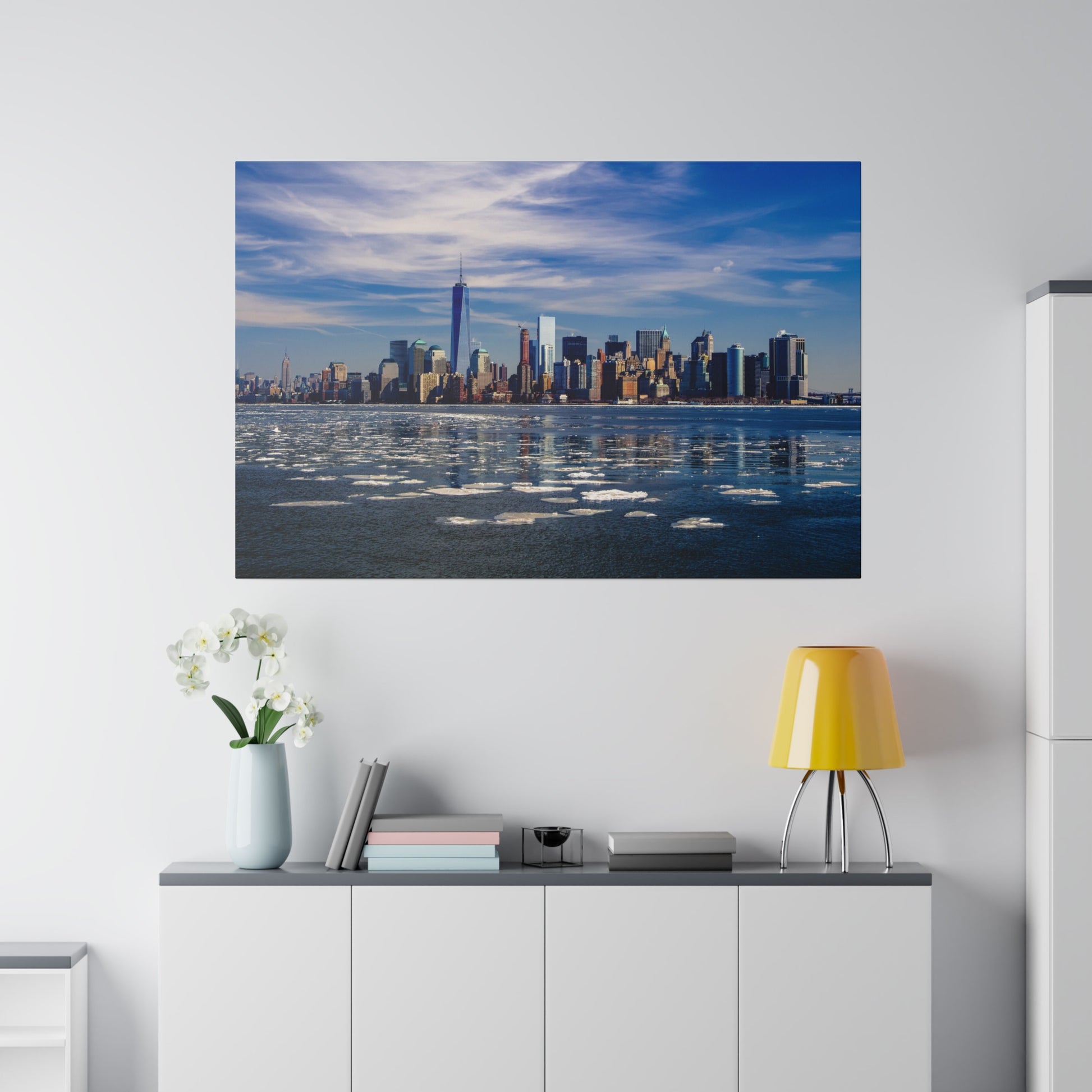 Cityscape of New York as seen from the river, featuring the skyline with floating ice and a serene water scene.