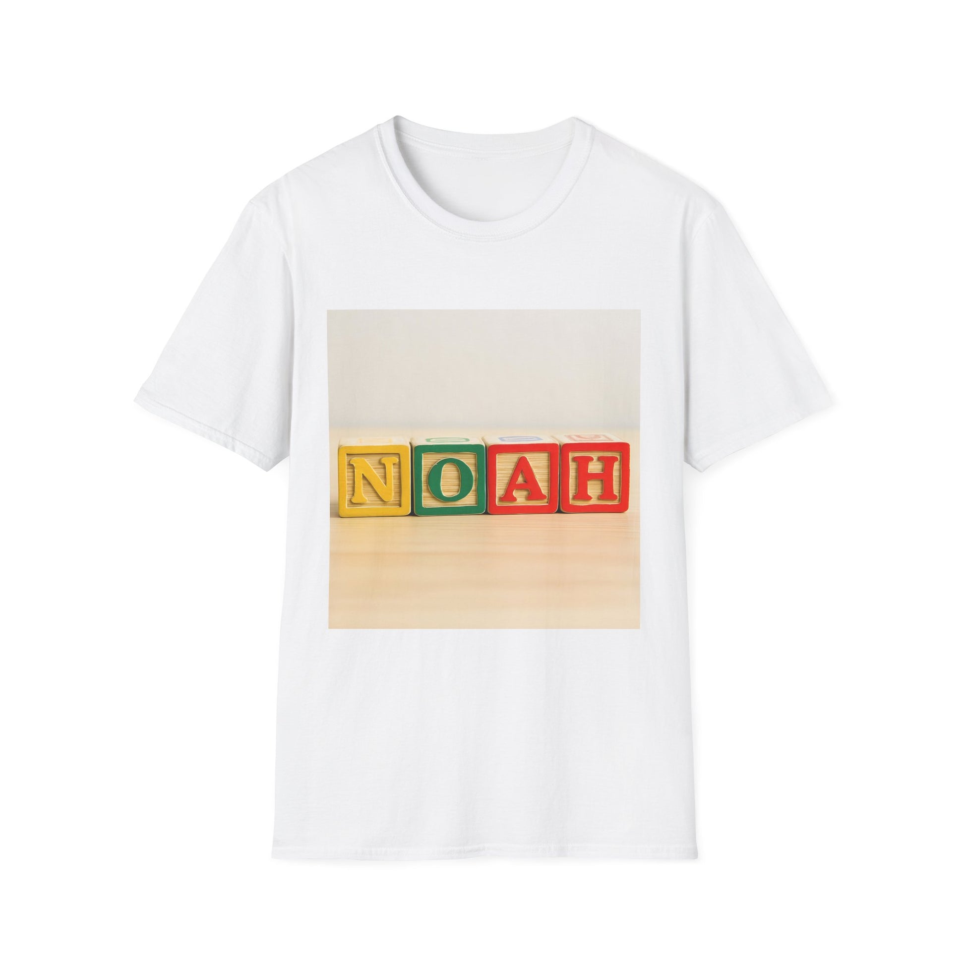 White T-shirt featuring a printed photo of four colorful wooden blocks spelling NOAH on a light wooden surface.