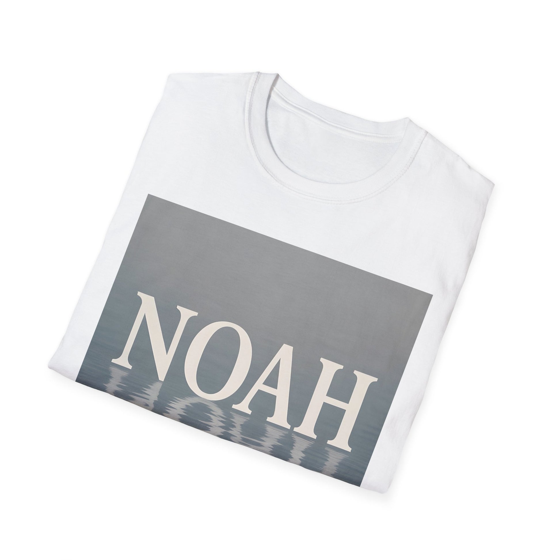 White T-shirt folded, front features a gray-blue rectangle with the word NOAH in large white letters and a water reflection at the bottom.