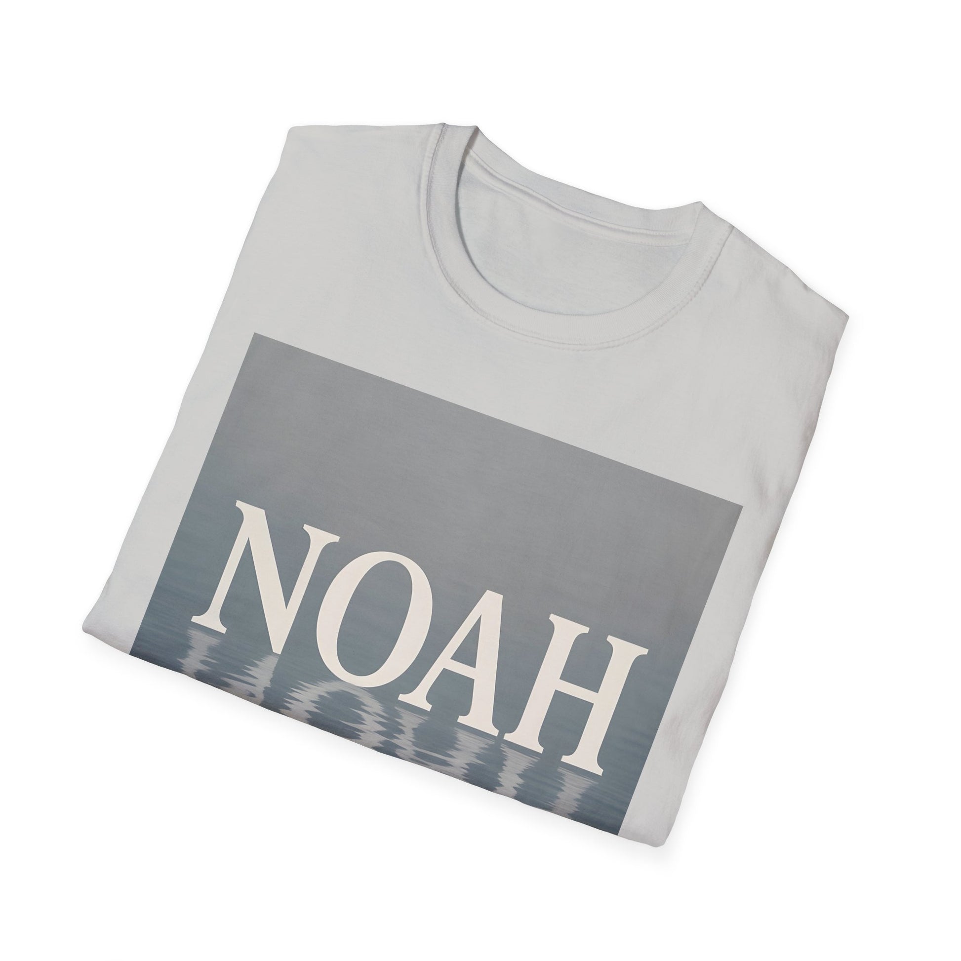 Light gray folded T-shirt featuring a large gray rectangle graphic with the word NOAH in white and a water-reflection pattern at the bottom.
