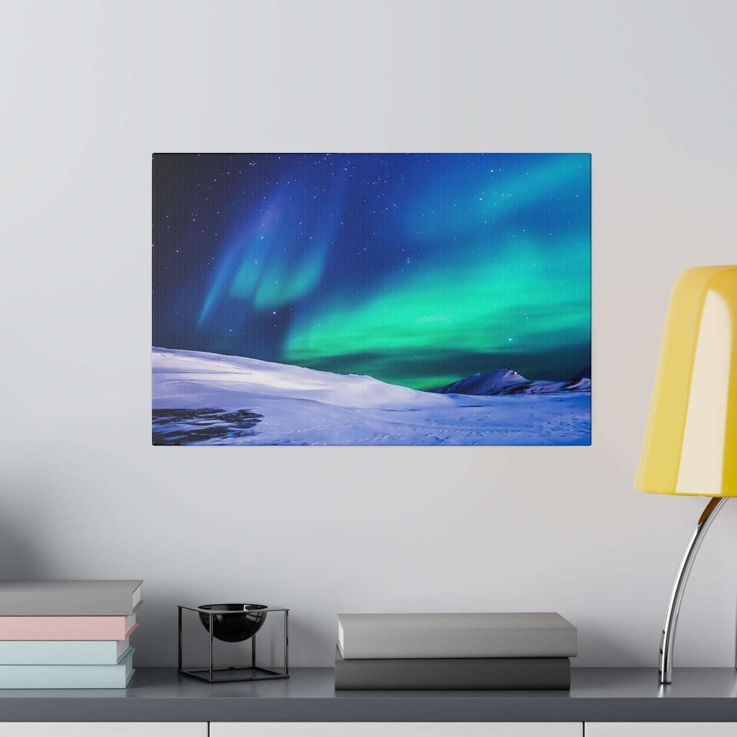 Canvas art print showing a snowy landscape with green-blue aurora borealis under a starry night sky.