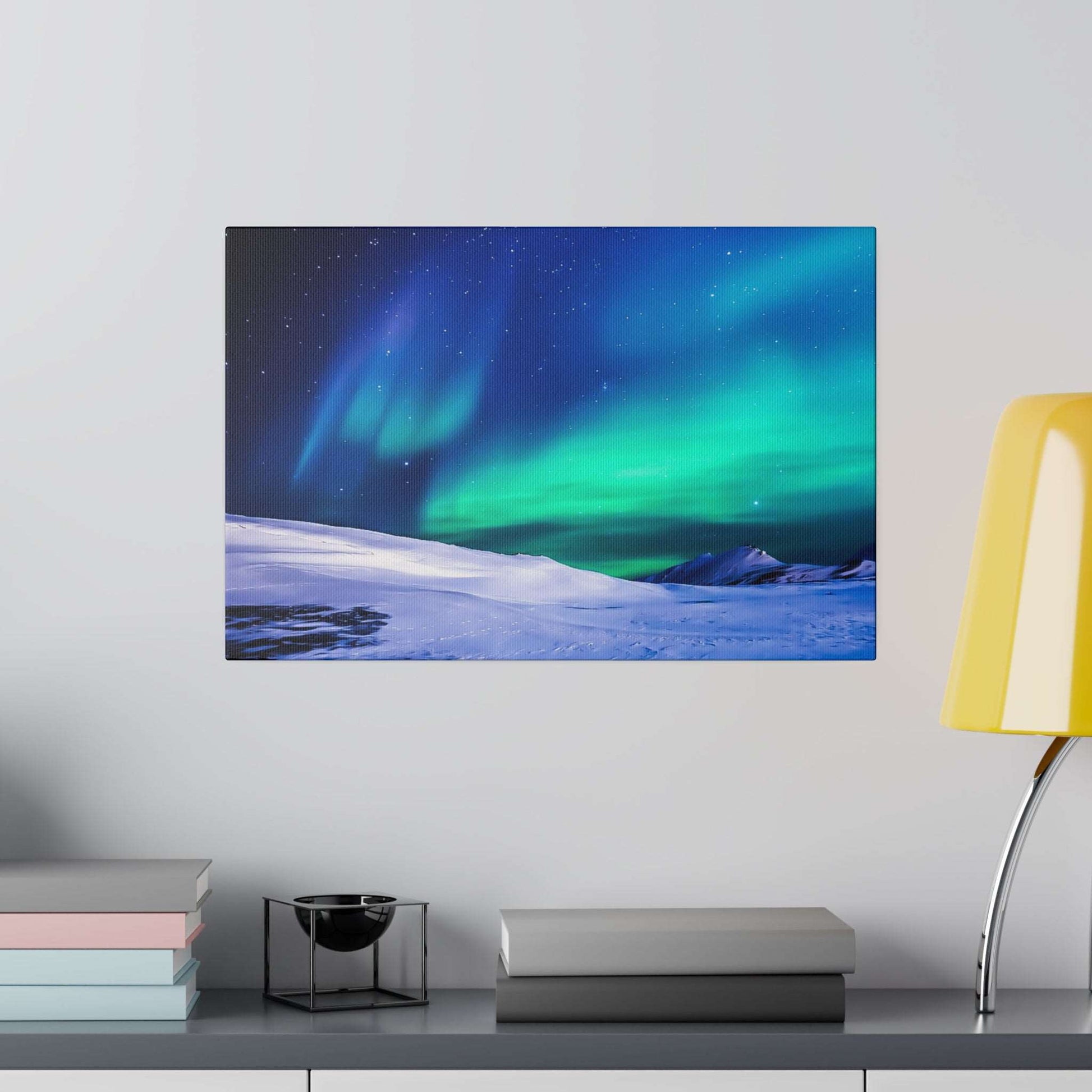 Canvas art print showing a snowy landscape with green-blue aurora borealis under a starry night sky.