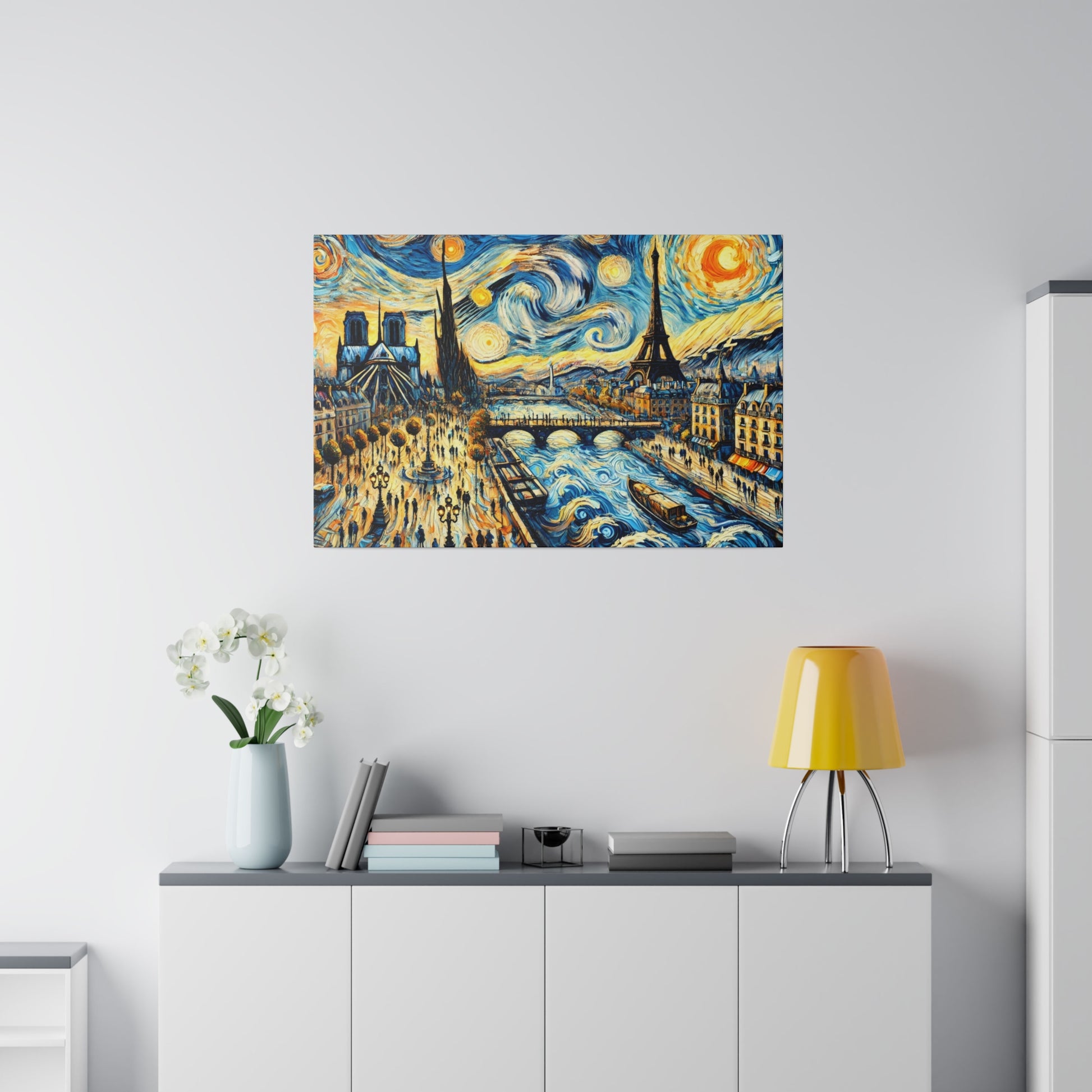 Colorful painting of a Paris river scene with swirling skies, hung above a white cabinet with a yellow lamp and vase.
