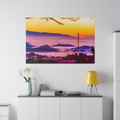 Large wall art showing a vibrant sunrise over misty purple mountains, with silhouetted trees and a tall antenna.