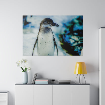 Poster of a penguin standing on ice with a blue, rocky background, hung above a white cabinet in a modern room.