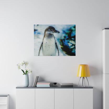 Photograph of a penguin on a wall above a white sideboard with a yellow lamp and books in a modern living room.