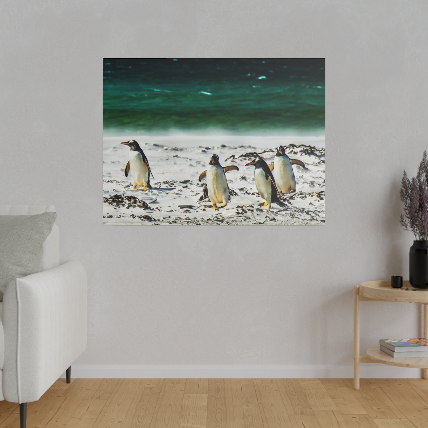 Penguins trekking across a beach, with the vibrant green-blue ocean behind them. The serene scene captures the penguins’ natural environment.