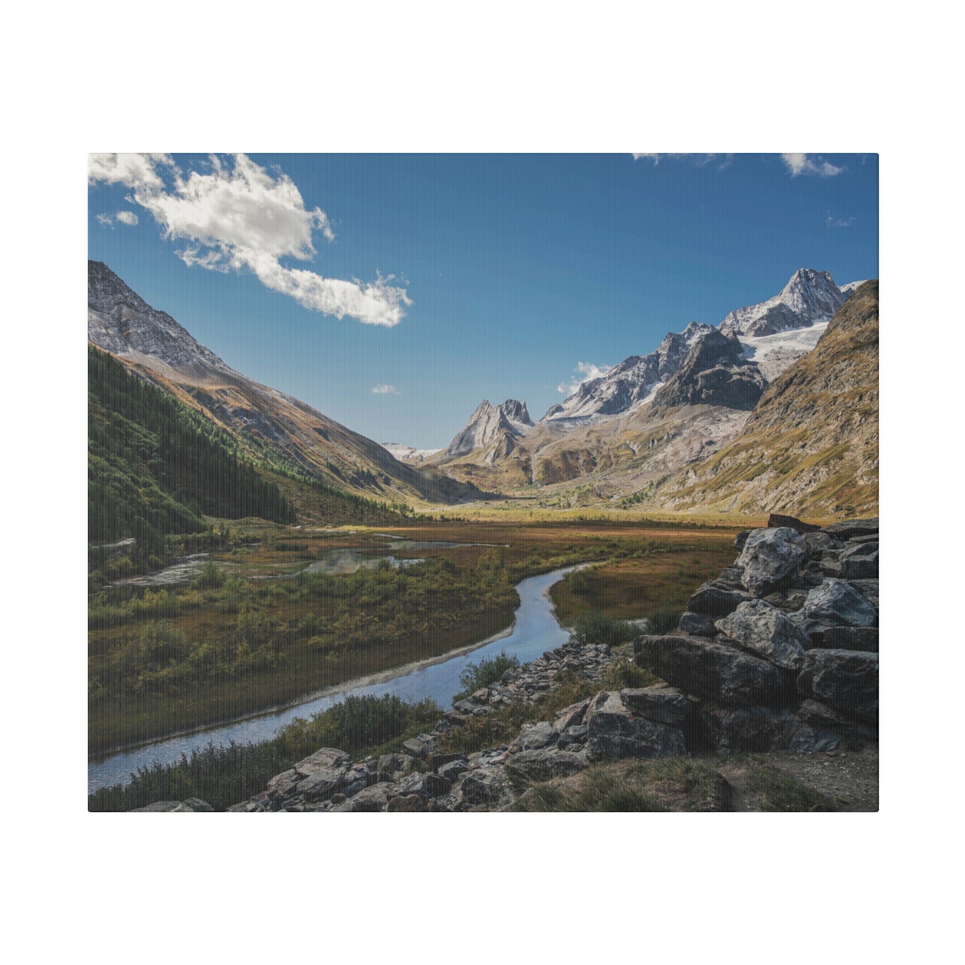 Winding river in a valley with green meadows, rocky foreground, and snow-capped mountains under a blue sky.