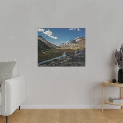 Landscape wall art depicting a mountain valley with a winding river, rocky foreground and blue sky.