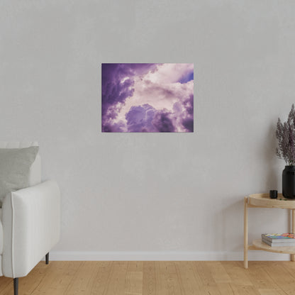 Small square art print of purple and pink cloudy sky hung on a gray wall in a living room.