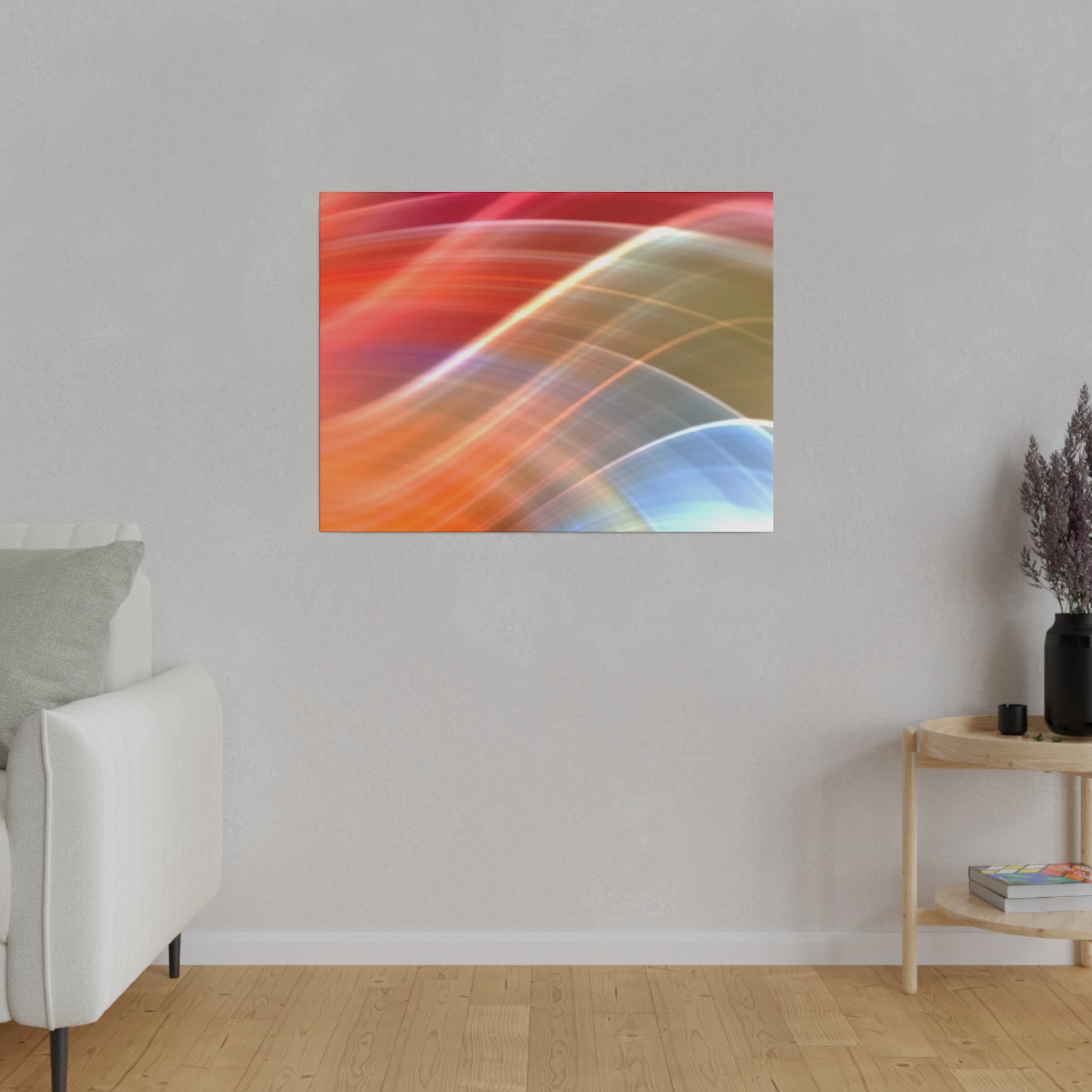 Abstract colorful wall art with sweeping orange, red, blue, and yellow curves mounted on a light gray wall.
