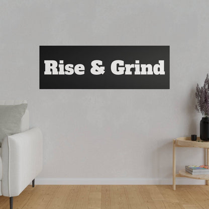 Living room wall with a black rectangular sign reading "Rise & Grind" in white bold letters.
