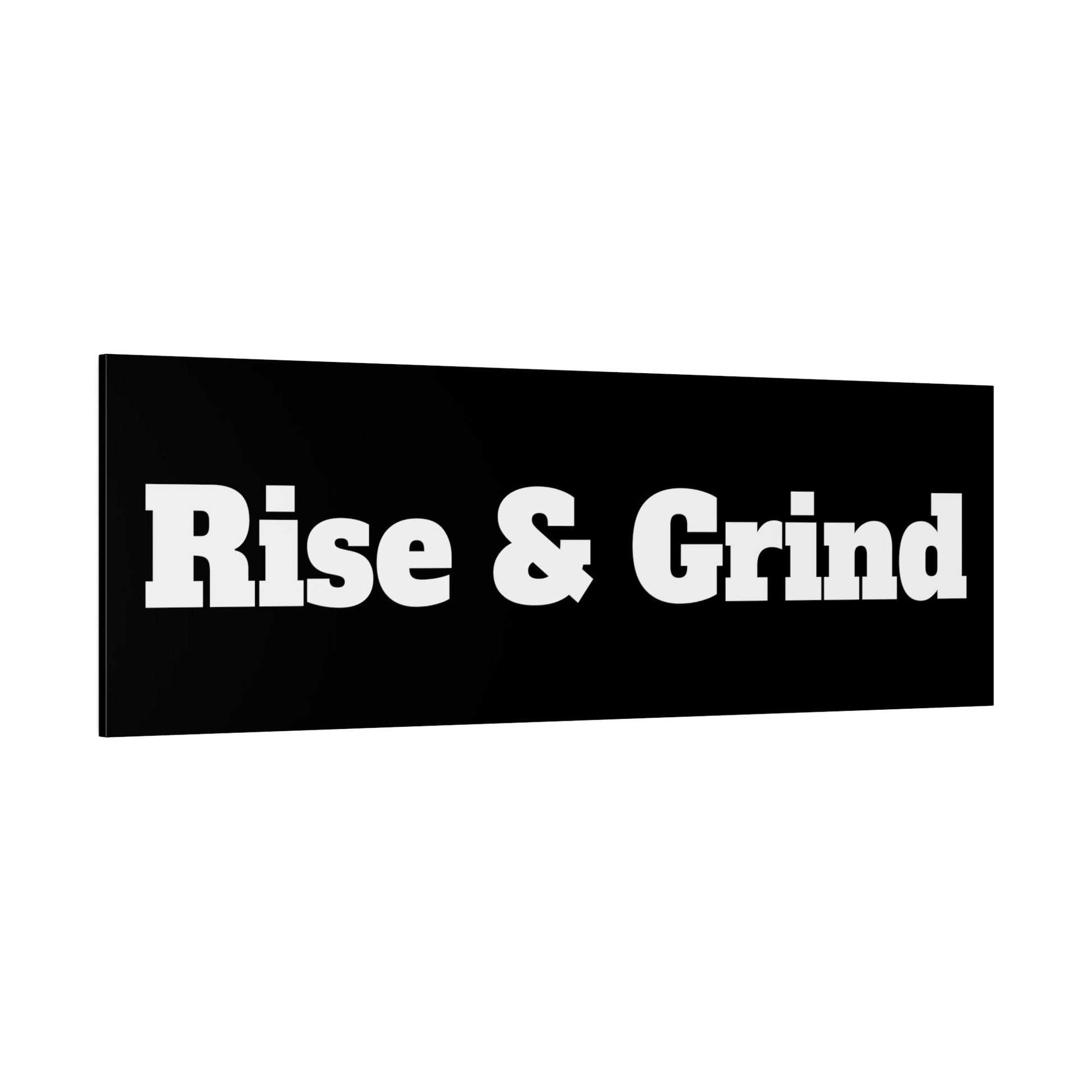 Black rectangular sign with large white text reading "Rise & Grind".