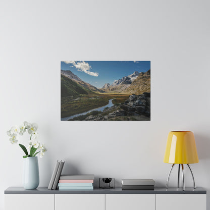 Mounted landscape photo of a mountain valley with a winding river, rugged rocks, and snow-capped peaks.