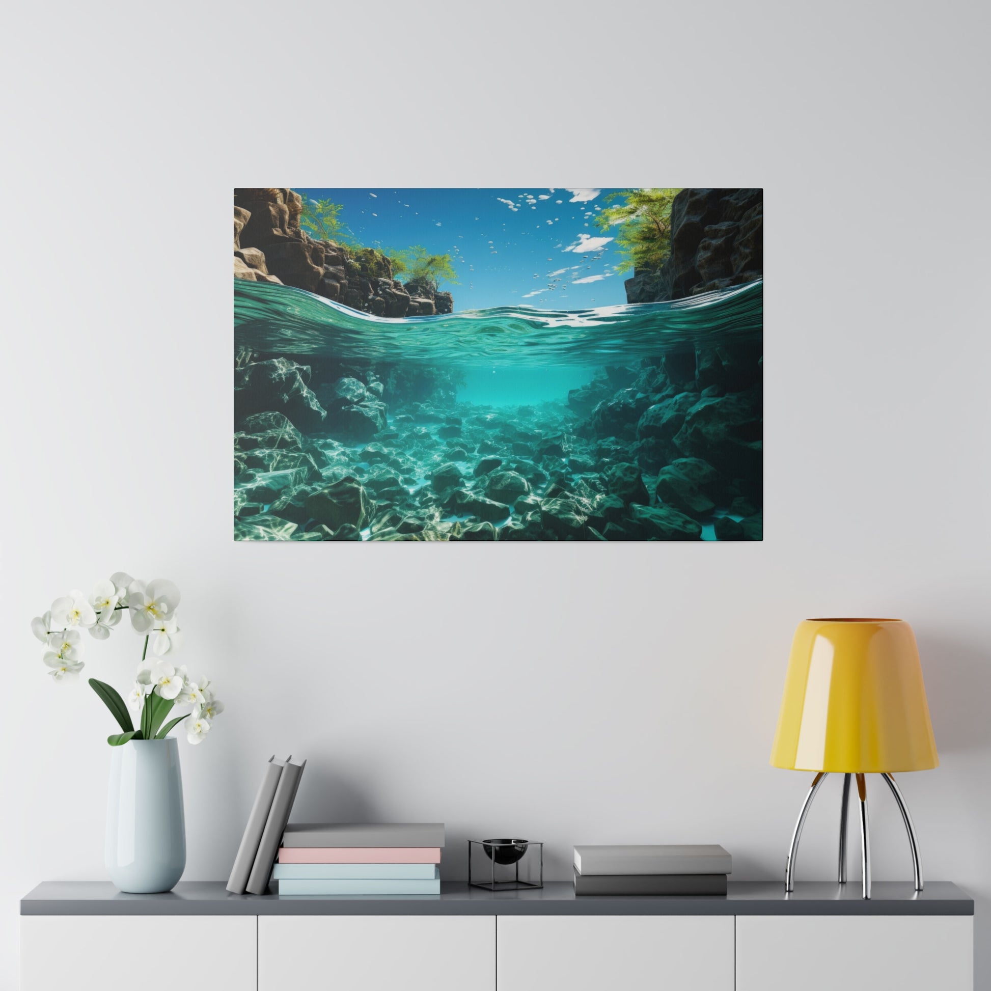 An underwater view of a riverbed with clear water, showcasing the rocks and plants beneath the surface. The scene is tranquil and picturesque.