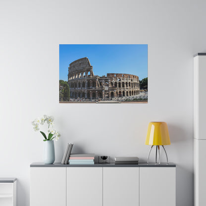 Color photograph of the Roman Colosseum in Italy, showing its stone arches and outer walls under a clear blue sky.