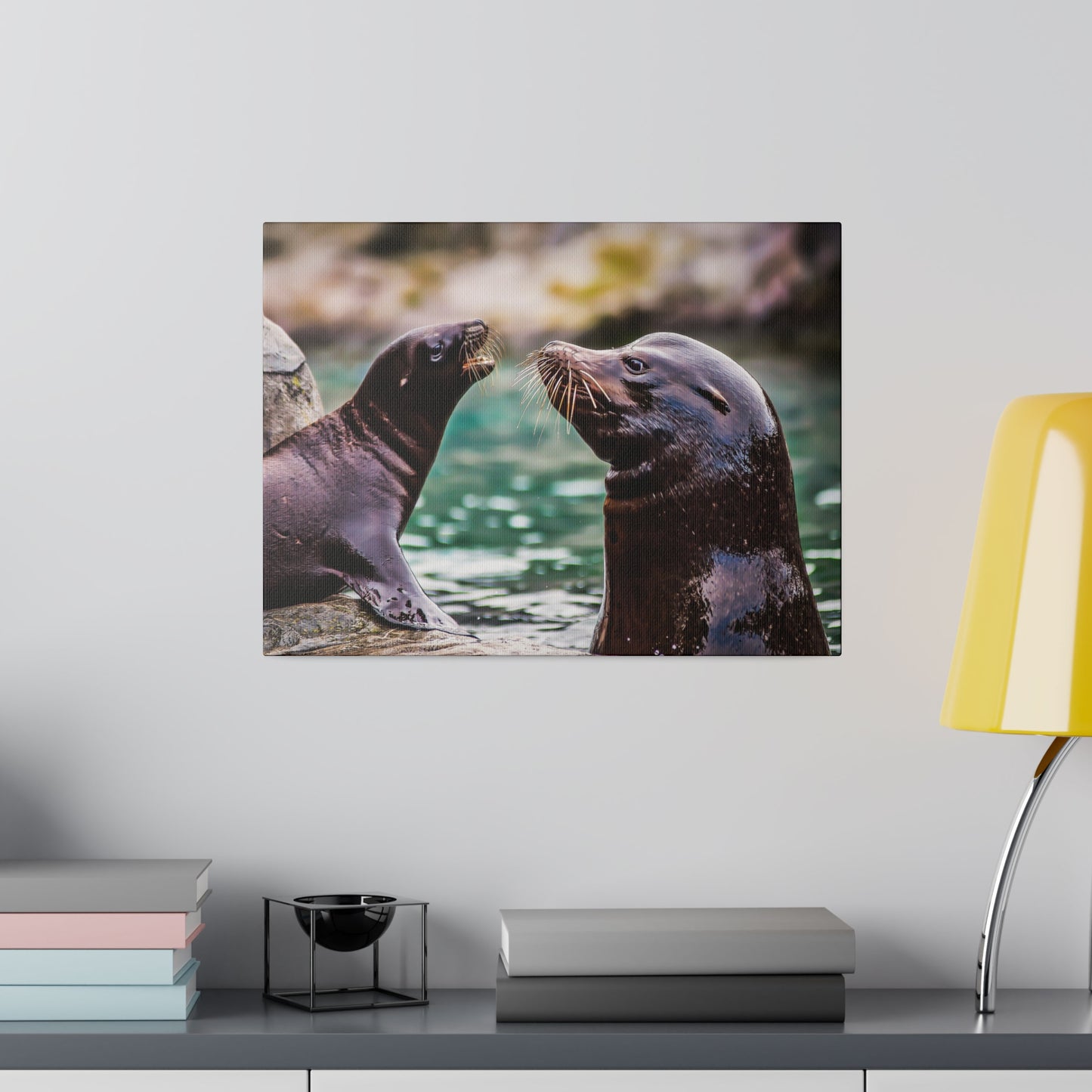 Sea lions bonding by the water's edge, with their whiskers and sleek fur prominently visible. The interaction showcases their playful and curious nature.