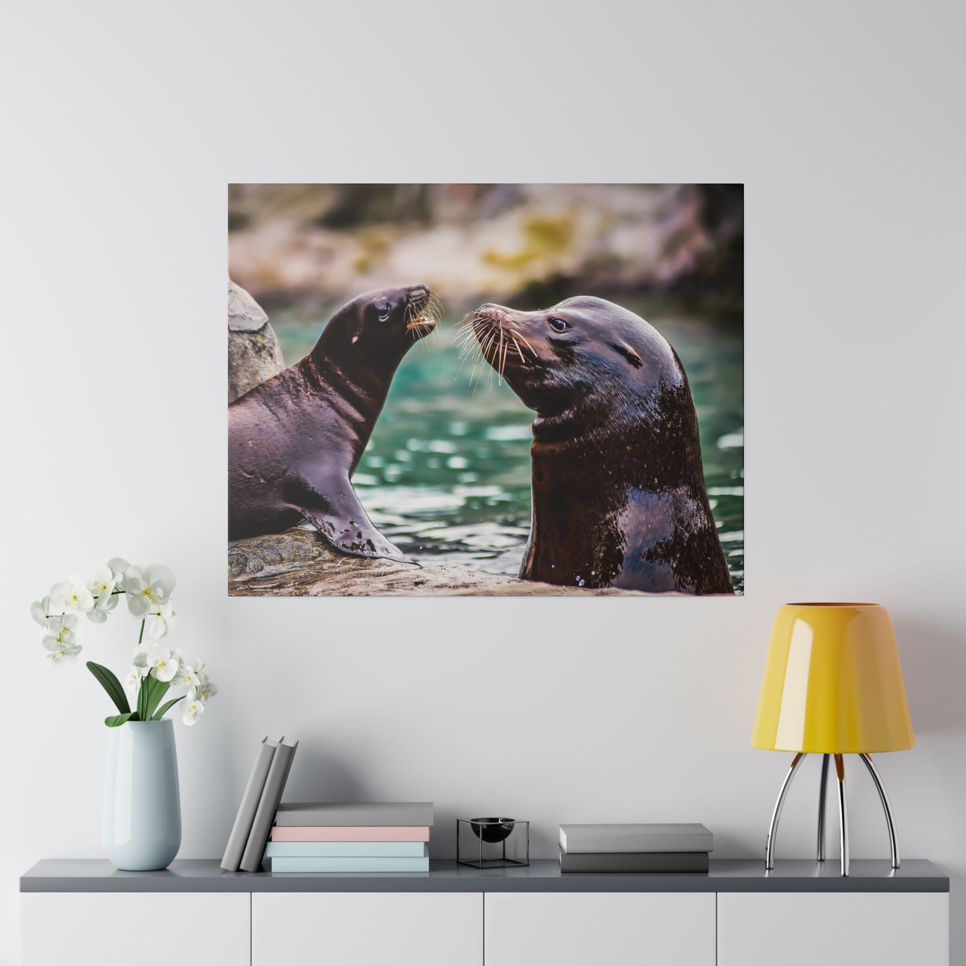 A duo of sea lions interacting by the water. The scene showcases their whiskers and smooth fur, emphasizing their social and playful nature.