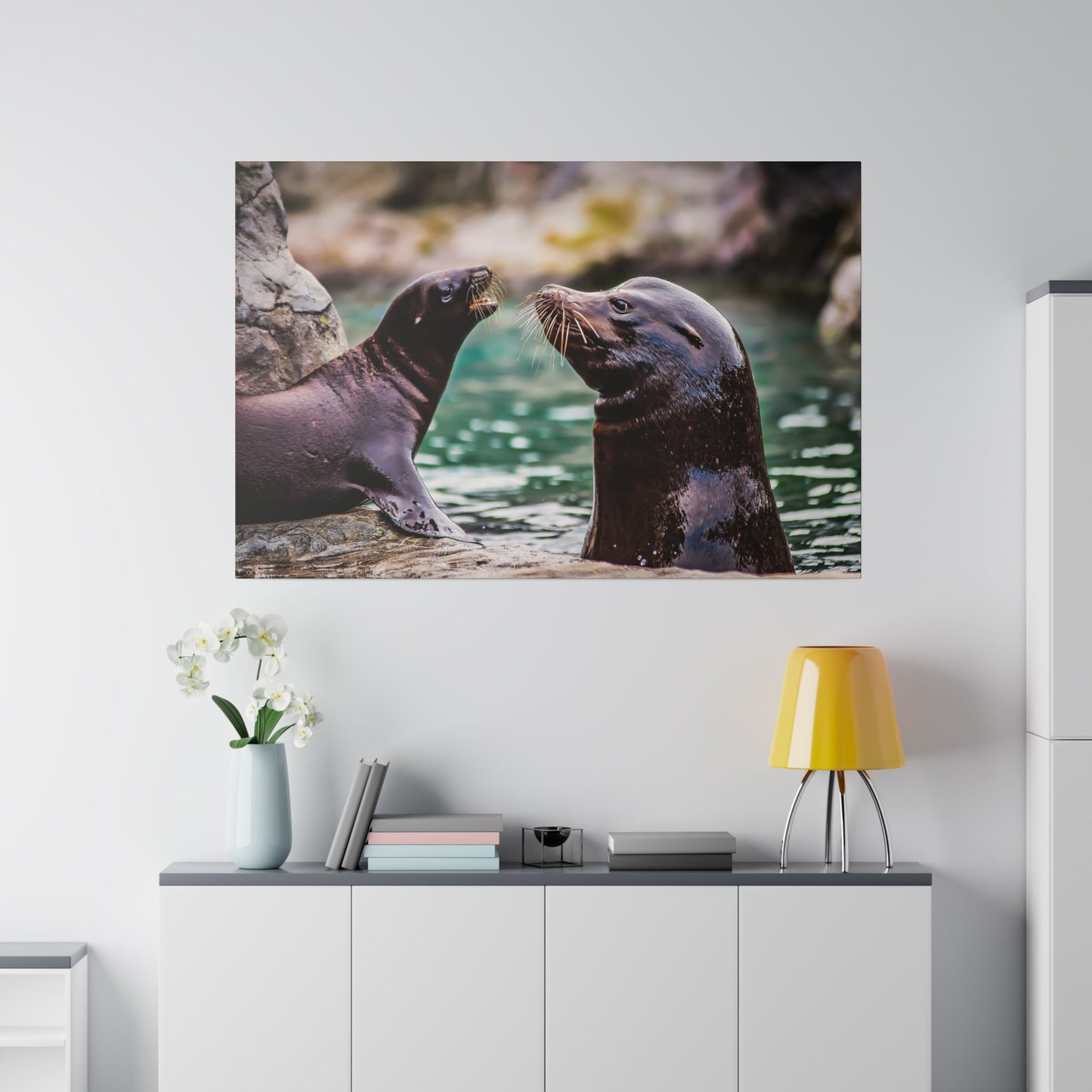 Sea lions frolicking in the water, showcasing their whiskers and sleek fur. The playful interaction highlights their fun-loving and social nature.