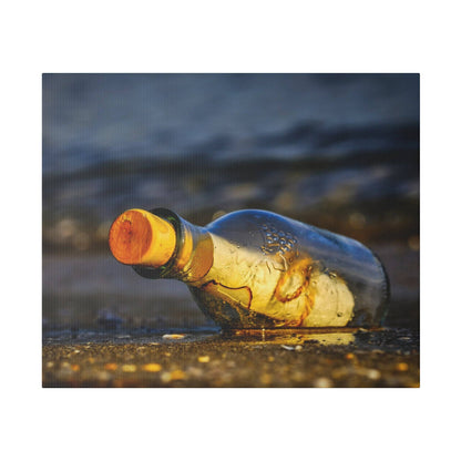 A clear glass bottle with an orange cap lies on a wet sandy beach near the shoreline.