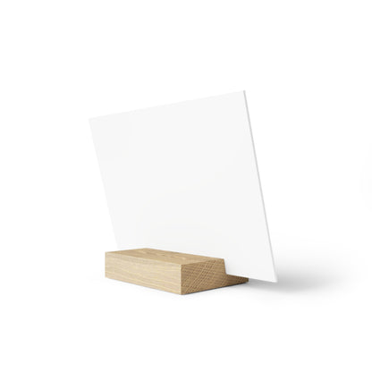 White square display card mounted on a light wood block stand, angled slightly.