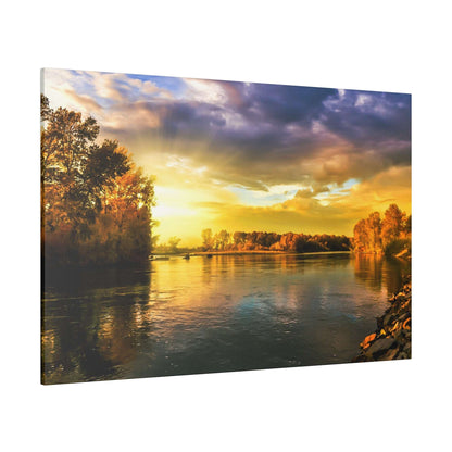 River scene at sunset with trees along the shore and golden sunlight reflecting on calm water.